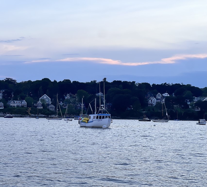 A lobster boat on its mooring with a bunch of buoys on board